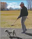  ?? ?? Taos resident Barry Brisko walks his dog, Gizmo, at Fred Baca Park, located at 940 Salazar Road.