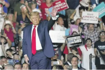  ?? JOHN RAOUX/AP ?? President Donald Trump waves to supporters at the Orlando Sanford Internatio­nal Airport on Monday in Sanford, Florida.