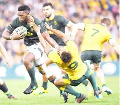  ??  ?? South Africa’s Siya Kolisi (left) pushes away Australia’s Will Genia during the Rugby Championsh­ip at Lang Park in Brisbane, Australia in this Sept 8 file photo. — Reuters photo