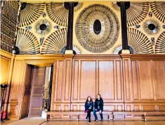  ??  ?? Visitors dwarfed by antique displays of arms in the Guard Chamber at Hampton Court