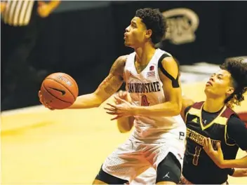  ?? K.C. ALFRED U-T ?? SDSU’s Trey Pulliam drives past Saint Katherine’s Kamron Fleming during SDSU’s win at Viejas Arena.