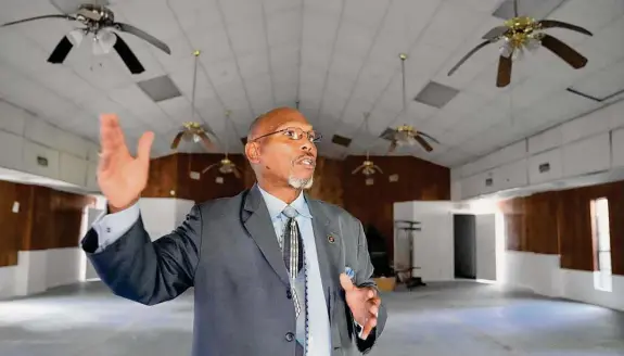  ?? Melissa Phillip/Staff photograph­er ?? William H. King III, the pastor of Greater New Hope Missionary Baptist Church in Dickinson, speaks below ceiling fans that are still damaged from Harvey.