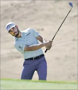  ?? Tom Dulat Getty Images ?? ABRAHAM ANCER chips onto the fifth hole en route to an opening-round seven-under 63 at the Saudi Internatio­nal, a stop on the Asian Tour.