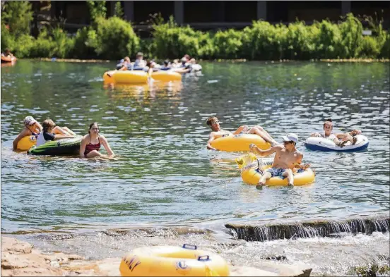  ?? RICARDO B. BRAZZIELL/AMERICAN-STATESMAN 2017 ?? Tubers float the San Marcos River at Rio Vista in August 2017. If you come prepared, your tubing trip will go much more smoothly.