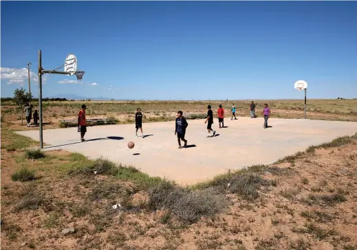  ??  ?? Students play basketball at Little Singer Community School in Arizona on the Navajo reservatio­n. — Pictures/Ti Gong