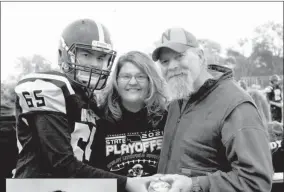  ?? Donna Hoblyn-Bittner ?? Pictured above is Jacob Hoblyn-Bittner with his parents, Donna and Shain, at last fall’s football parents’ night. At left, is Jacob’s sophomore class photo at Ansley High School.