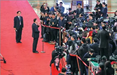  ?? KUANG LINHUA / CHINA DAILY ?? Ma Junsheng, head of the State Post Bureau, takes questions from reporters along the “ministers’ passage” before the closing of the National People’s Congress annual session in Beijing on Wednesday. The “ministers’ passage”, also known as “the...