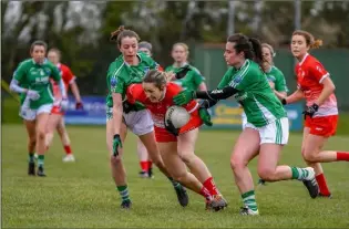  ??  ?? Louth’s Kate Flood breaks away from two Fermanagh defenders during Sunday’s Lidl NFL clash in Tullyallen.