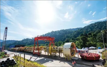  ?? ZHU WEI / XINHUA ?? A massive Chinese-made tunnel boring machine is deployed to spearhead excavation works for the Genting Tunnel of the East Coast Rail Link near Bentong in Pahang state, Malaysia, on Jan 13. The Belt and Road Initiative has promoted economic prosperity and sustainabl­e developmen­t in developing countries.