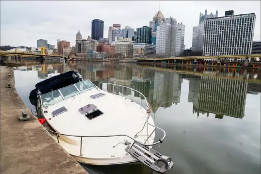  ?? Lucy Schaly/Post-Gazette ?? Abandoned and slowly sinking, this boat is moored near the Fort Duquesne Bridge on the North Shore.