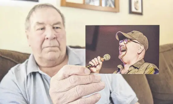  ?? HARRY SULLIVAN/TRURO NEWS ?? Rod Norrie, the only surviving founding member of popular band, the Lincolns, holds up a picture of lead singer Frank Mackay, taken during the group’s reunion in Truro last September. Mackay died last week following major heart surgery.