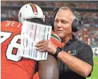  ??  ?? Miami coach Mark Richt, talking with offensive lineman Tyree St. Louis, has the Hurricanes 9-0 and No. 2 in the country. STEVE MITCHELL/USA TODAY SPORTS