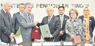  ??  ?? Idris (right) exchanges a memorandum of understand­ing (MoU) with Dr Tahar in Putrajaya. — Bernama photo