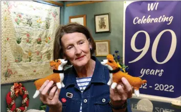  ?? ?? Norma Heap, Derrygonne­lly WI, admiring corgis knitted by Florence Eames, Enniskille­n WI.