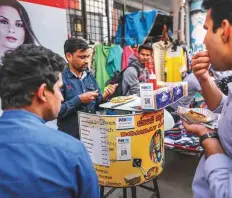  ?? Bloomberg ?? A street food stall in Bengaluru accepting PayTM payments. In India, digital payments have risen more than five times since 2015 to 22.4 transactio­ns per person in the year ended March.