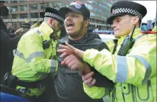 ?? MARTIN POPE / GETTY IMAGES ?? A man is arrested during a demonstrat­ion in support for Palestinia­ns on Thursday in Manchester, England.