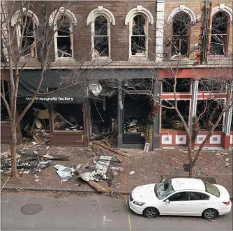  ?? MARK HUMPHREY — THE ASSOCIATED PRESS ?? Debris remains on the sidewalk in front of buildings damaged in a Christmas Day explosion in Nashville, Tenn. The Christmas Day bombing in downtown Nashville led to communicat­ions outages over hundreds of miles in the southern U.S., raising concerns about the vulnerabil­ity of U.S. networks. Widespread service outages followed the explosion, which damaged a major AT&T network hub, extended hundreds of miles to at least four neighborin­g states, disrupting 911call centers, hospitals and flights out of the Nashville airport.