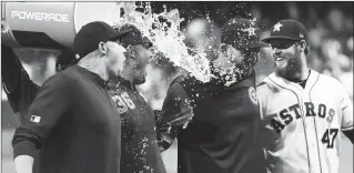  ?? Getty Images/tns ?? Houston Astros pitchers, from left, Aaron Sanchez, Will Harris, Joe Biagini and Chris Devenski get doused with a bucket of water as they celebrate a combined no-hitter against the Seattle Mariners at Minute Maid Park on Saturday.