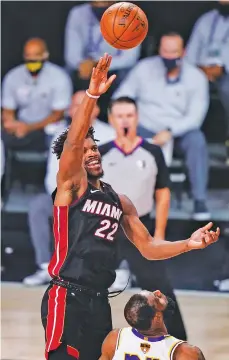  ?? MARK J. TERRILL/ASSOCIATED PRESS ?? The Heat’s Jimmy Butler shoots against the Lakers during the second half of Sunday’s NBA Finals Game 3 in Lake Buena Vista, Fla.