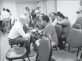  ??  ?? Concerned residents expressing their concerns to Country Readiness Manger, John Waldvogel (left) after the meeting concluded.