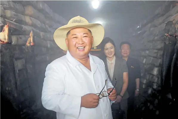  ??  ?? Kim Jong-un, North Korea’s Supreme Leader, was dressed for the heat when he visited the Samchon Catfish Farm with his wife Ri Sol Ju, right, in South Hwanghae province