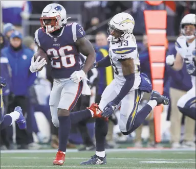  ?? Charles Krupa / Associated Press ?? Patriots running back Sony Michel ran for three touchdowns against the Chargers in Sunday’s AFC divisional playoff game in Foxborough, Mass.