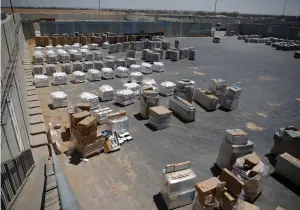  ?? (Amir Cohen/Reuters) ?? GOODS AWAIT TRANSFER to the Gaza Strip through the Kerem Shalom border crossing terminal yesterday.