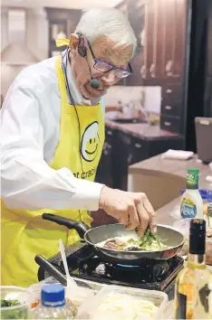  ??  ?? Howard Helmer, the world’s fastest omelette chef, makes an omelette at Canadian Western Agribition on Monday.