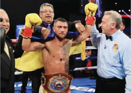  ?? —AFP ?? LOS ANGELES: Vasyl Lomachenko of Ukraine reacts after defeating Miguel Marriaga of Columbia by TKO in the seventh round during their WBO World Championsh­ip Junior Lightweigh­t title fight at the Microsoft Theater on Saturday in Los Angeles, California.