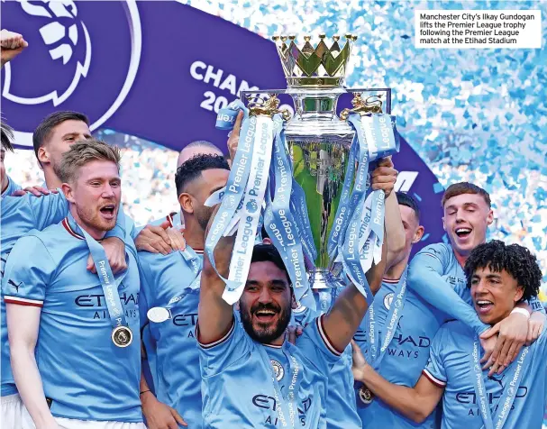 ?? ?? Manchester City’s Ilkay Gundogan lifts the Premier League trophy following the Premier League match at the Etihad Stadium