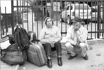  ??  ?? Mexican Nationals wait for their bus after crossing the US-Mexico Border at the San Ysidro Port of Entry on Friday. — AFP photo