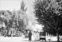  ?? THE ASSOCIATED PRESS ?? Smoke rises from a building after a deadly attack including a suspected suicide car bombing and gun battles, in Jalalabad, Afghanista­n, Tuesday. Nearly 20 people died and more than 40 people were hurt in the attacks.