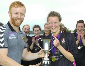  ??  ?? Méabh Kehoe, captain of Seaview United, receives the cup from Barry Dempsey.