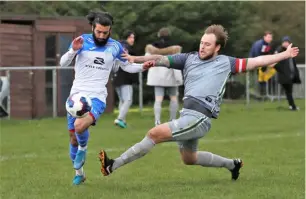  ??  ?? Paras Gill takes on an Ash United defender