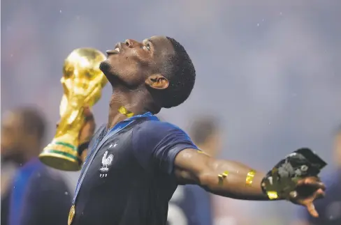  ?? NATACHA PISARENKO/ASSOCIATED PRESS ?? France’s Paul Pogba celebrates Sunday with the trophy after the final match between France and Croatia at the World Cup in the Luzhniki Stadium in Moscow. France beat Croatia, 4-2.