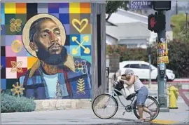  ?? Chris Pizzello Associated Press ?? A MURAL of Nipsey Hussle near his Marathon Clothing store. In the years leading up to his death, Hussle was rising both as a rapper and entreprene­ur.