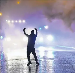  ?? PHOTO: GETTY IMAGES ?? A protester gestures to police on Springfiel­d Rd in Belfast last week during several nights of unrest in the city. Police are describing events as the worst scale of violence seen in Belfast for years.