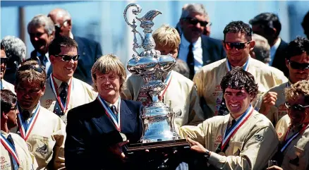  ??  ?? Peter Blake and Russell Coutts show off the America’s Cup with their Team New Zealand team members after their 1995 breakthrou­gh win.
