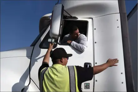  ?? PHOTOS BY JAE C. HONG — THE ASSOCIATED PRESS ?? Senior instructor Markus Juarez, bottom, talks to student driver Jaime Rojas at California Truck Driving Academy in Inglewood.