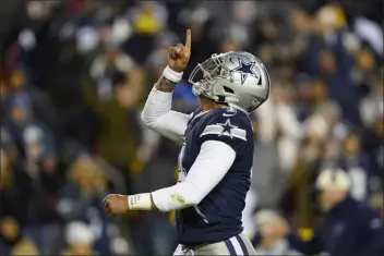  ?? PATRICK SEMANSKY — THE ASSOCIATED PRESS FILE ?? Dallas Cowboys quarterbac­k Dak Prescott points upward after scoring against the Washington Commanders during the first half an NFL football game Jan. 8in Landover, Md.