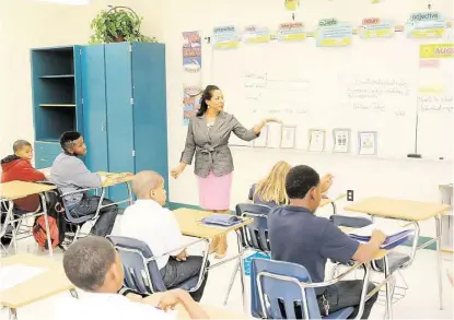  ?? Pin Lim / For the Chronicle ?? La Marque Independen­t School District Superinten­dent Terri Watkins visits pupils at La Marque Elementary School. She is hopeful that new initiative­s can help the school district rebound after being threatened with closure. Watkins, who became...