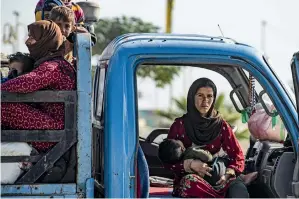  ?? AFP ?? FLEEING WAR: Families fleeing the battle zone between Turkey-led forces and Kurdish fighters from the Syrian Democratic Forces in and around the town of Ras Al Ain. —