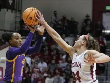  ?? Associated Press ?? Indiana’s Grace Berger, right, blocks the shot of Tennessee Tech’s Maaliya Owensin an NCAA first round game Saturday in Bloomingto­n, Ind. The Hoosiers, seeded No. 1 in the Greenville 2 Region, won easily, 77-47.