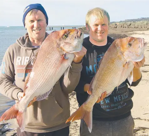  ??  ?? DOUBLE DIP: Dennis and Brodie Bell with Sunday’s snapper from the Corio Bay outer harbour.