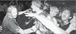  ?? Al Schaben Los Angeles Times ?? HOLLAND takes his set to the fans during a concert at UC Irvine around the time of the Offspring’s 1994 hit “Smash,” the band’s third studio album.