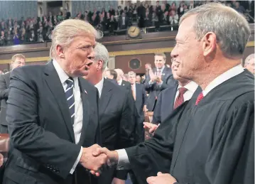  ?? AFP ?? US President Donald Trump shakes hands with US Supreme Court Chief Justice John Roberts.