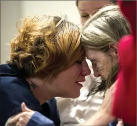  ?? (Arkansas Democrat-Gazette/Stephen Swofford) ?? Linda Veasey (left) hugs her grandmothe­r, Linda Ashley, during Friday’s graduation ceremony for an inmate program at the Pulaski County jail. More photos at arkansason­line.com/215csi/.