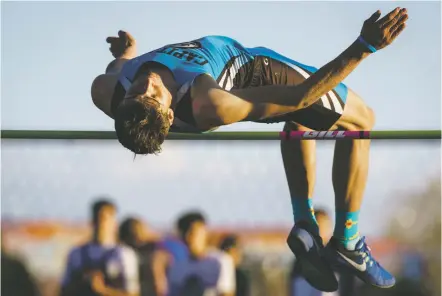  ?? PHOTOS BY CRAIG FRITZ/FOR THE NEW MEXICAN ?? Capital’s Lucas McNatt clears the high jump bar Tuesday during the Golden Spike Classic at Santa Fe High School. McNatt eventually cleared 5 feet, 10 inches — short of the 6 feet needed to automatica­lly qualify for the state meet.