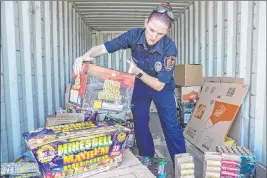  ?? Benjamin Hager Las Vegas Review-journal file @benjaminhp­hoto ?? Amanda Wildermuth, with Clark County Fire Prevention, organizes confiscate­d illegal fireworks at Clark County Fire Station 22 in July 2018.