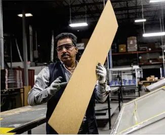  ?? ALYSSA POINTER/ALYSSA.POINTER@AJC.COM ?? A Lund Internatio­nal employee works to package a vent visor car accessory at the company’s plant in Lawrencevi­lle. Georgia’s auto-related facilities account for $2.8 billion of the state’s annual economy and several hundred thousand jobs, according to...